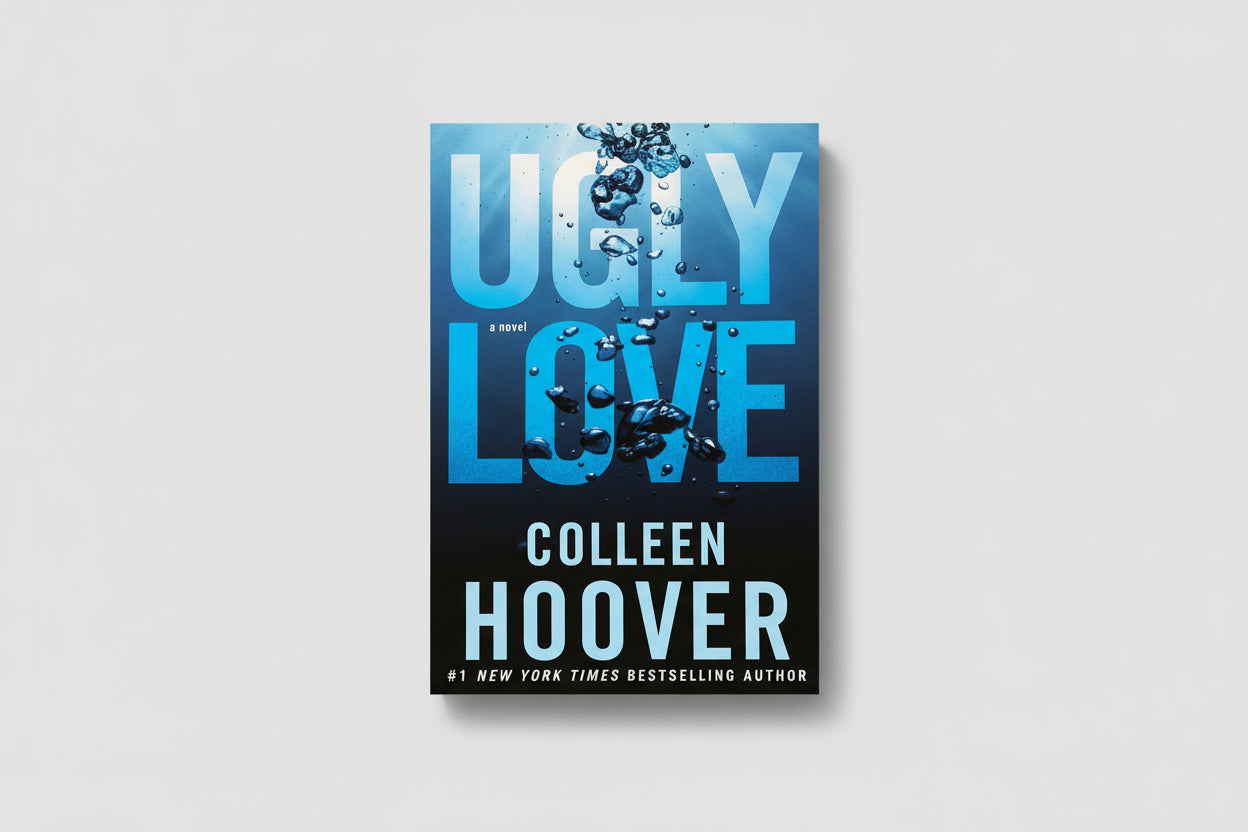 Book titled 'Ugly Love' by Colleen Hoover on a wooden surface